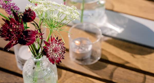A candle and flower on a table